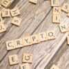 scrabble tiles spelling the word crypt on a wooden surface