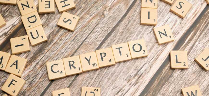 scrabble tiles spelling the word crypt on a wooden surface