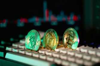 Cryptocurrency coins sit on a keyboard.