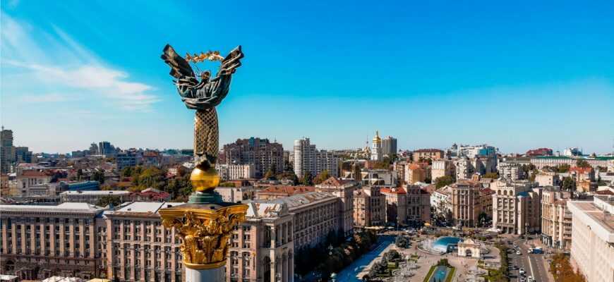 a view of a city with a statue in the middle